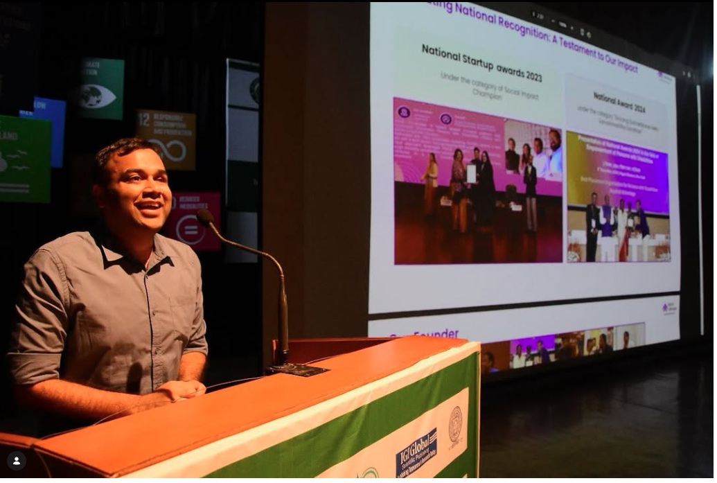 Speaker presenting on stage to a large audience